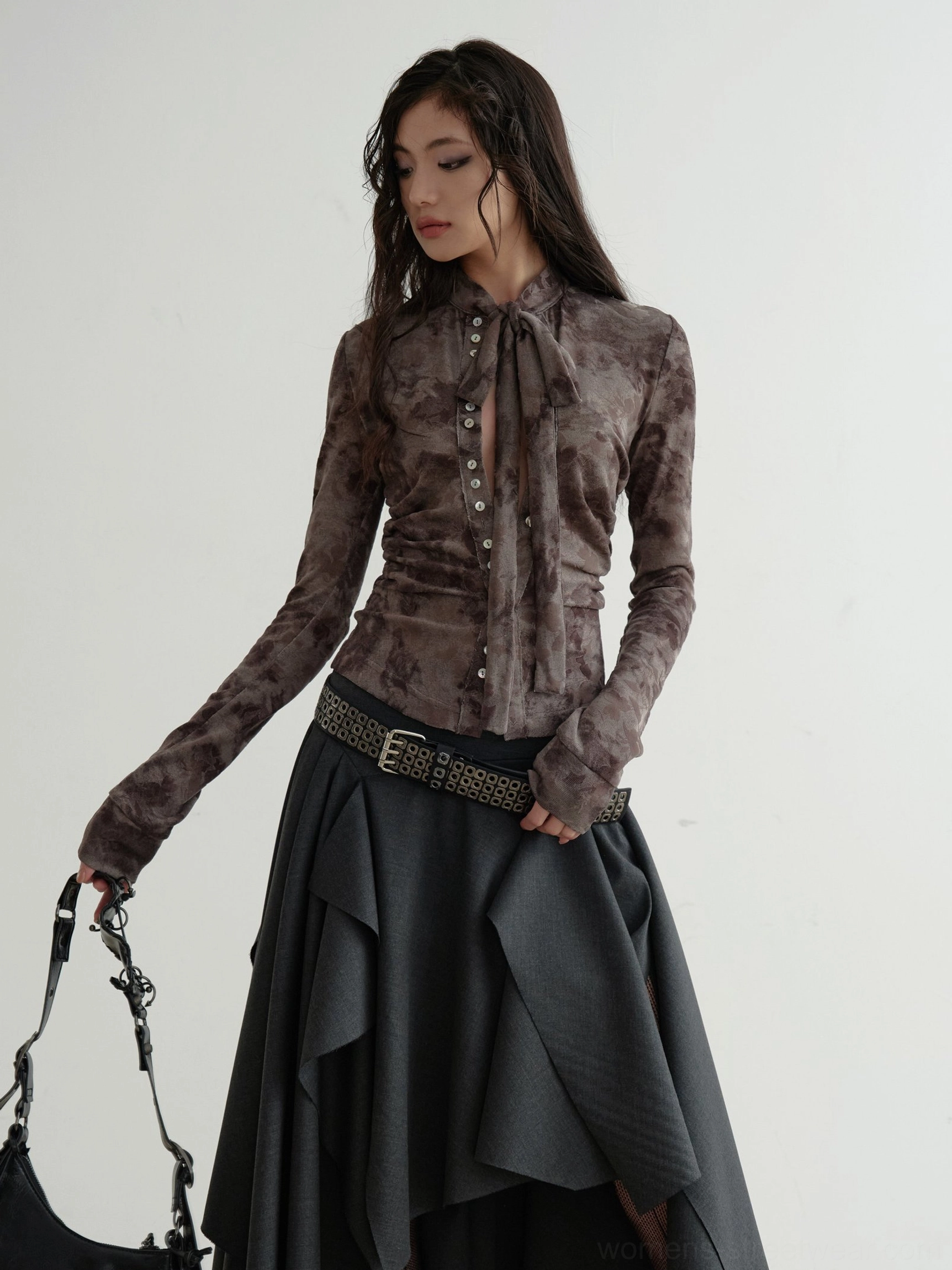 Brown marble print long-sleeve shirt styled with leather shoulder bag and midi skirt