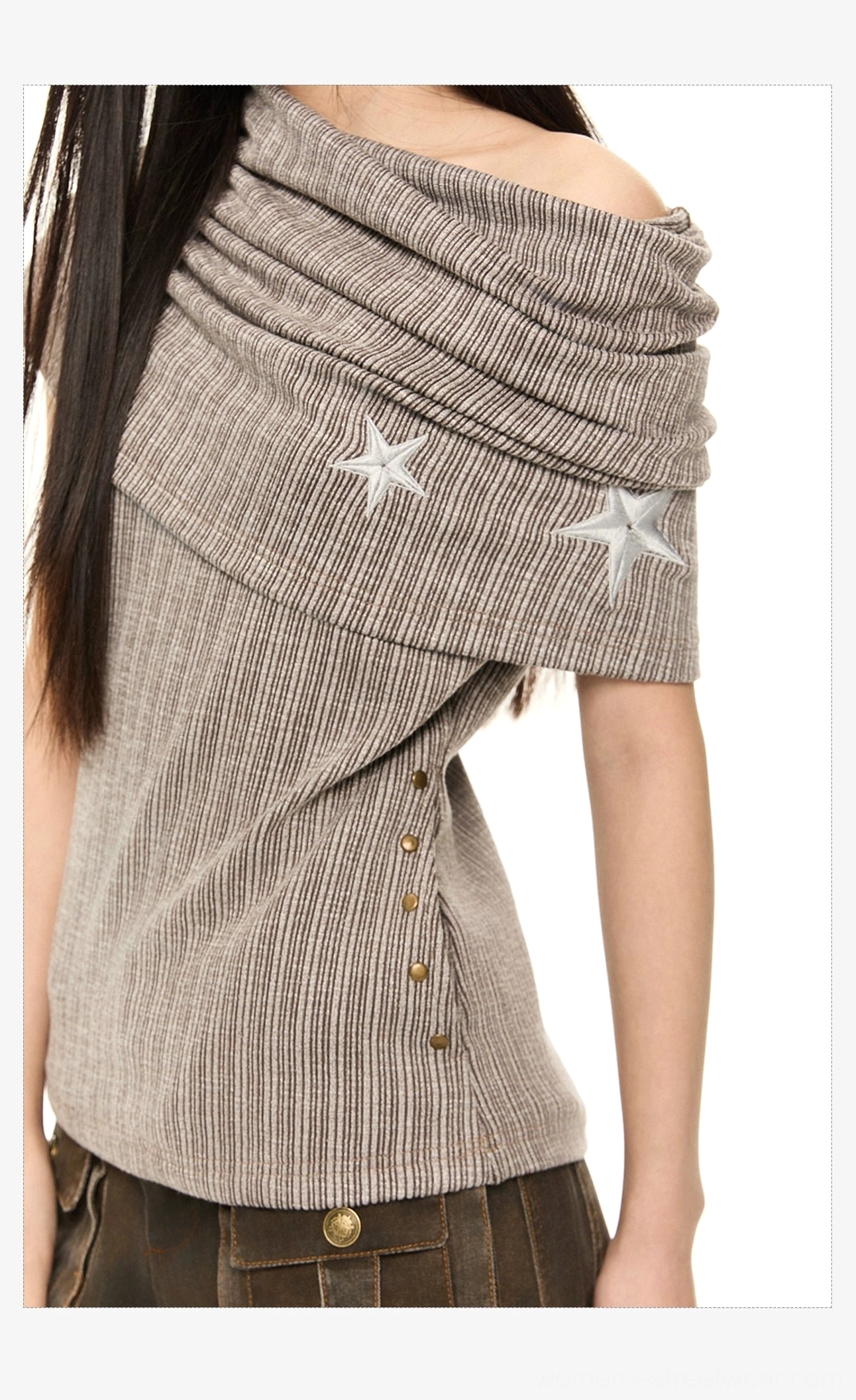 Close-up of brown pinstripe off-shoulder knit top with two embroidered stars, twisted draped neckline, and metal side snap details