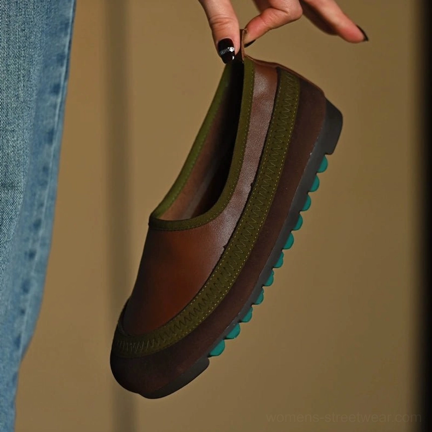 Top-down view of brown and olive green cowhide leather slip-on shoes with green collar trim and studded rubber outsole
