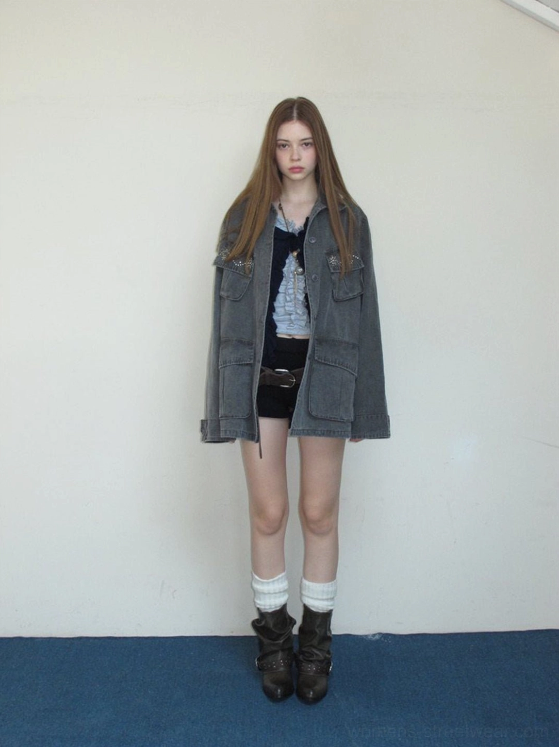 Brown olive slouchy cowhide ankle boots worn with a denim jacket, layered tops, and black shorts