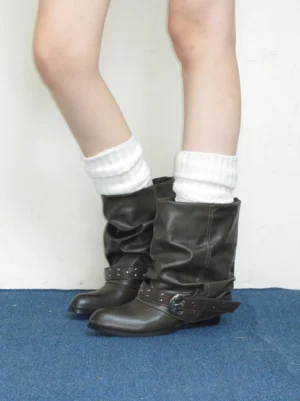 Brown olive leather ankle boots shown from the rear with white ribbed socks and a relaxed streetwear outfit