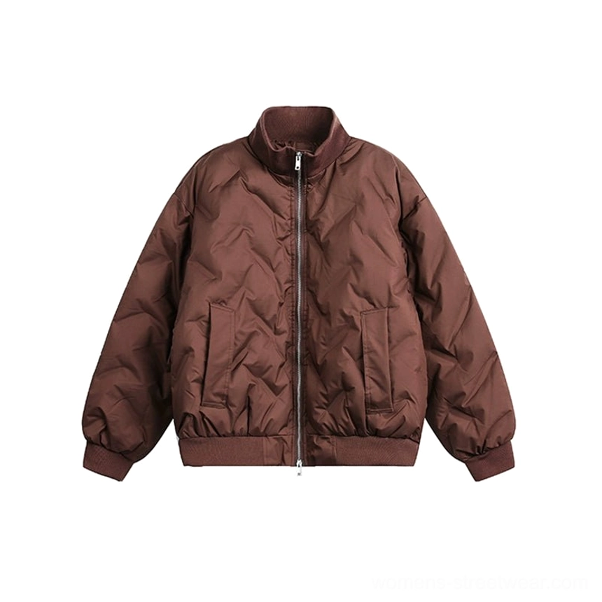Flat front studio view of a brown oversized chevron quilted puffer bomber jacket with matte fabric, ribbed trim, and side pockets
