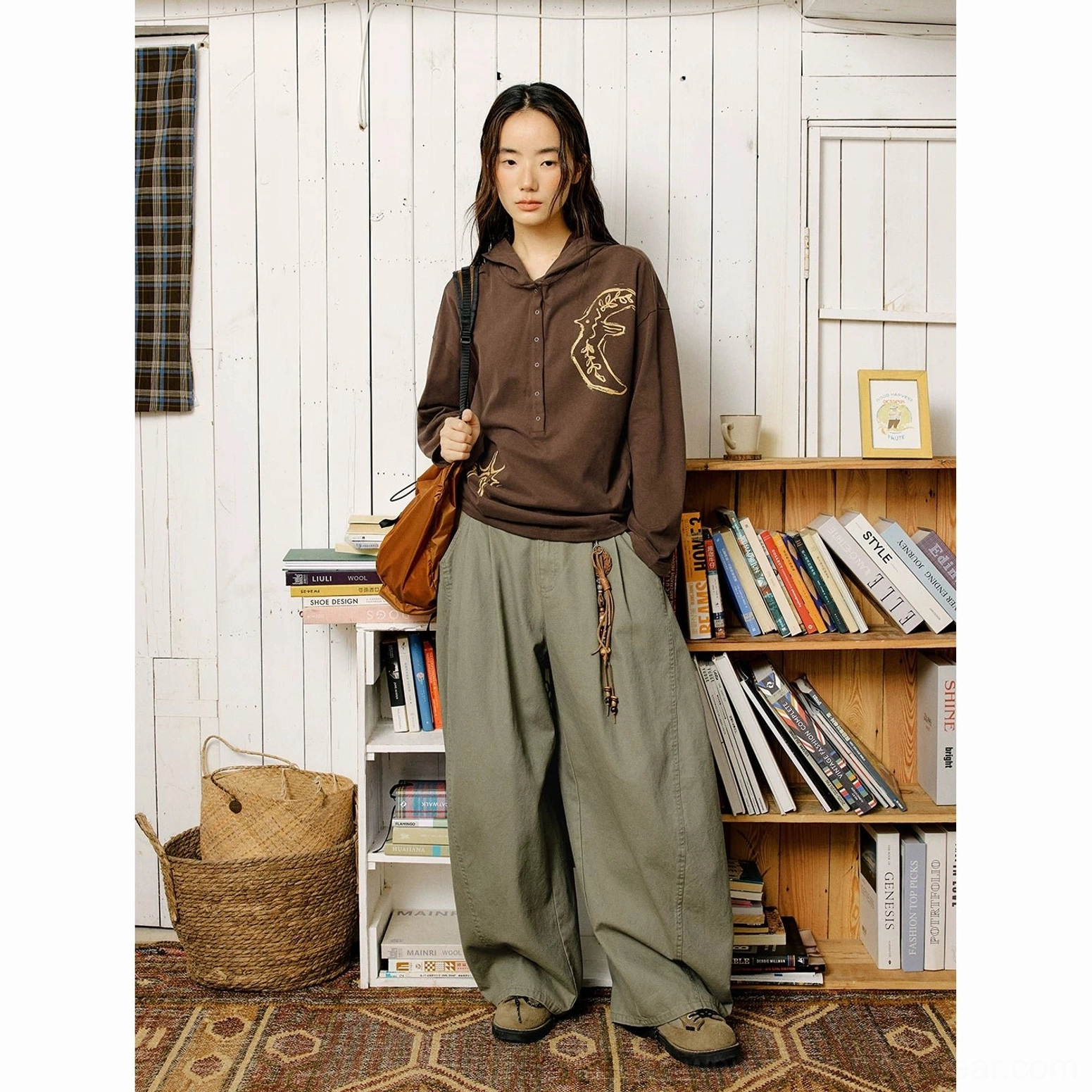 Brown oversized embroidered graphic Henley polo shirt with artistic details and relaxed contemporary streetwear styling