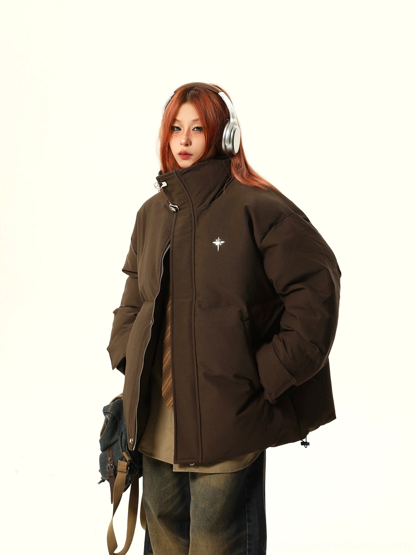 Brown oversized puffer jacket side silhouette with adjustable drawstring hem and crossbody bag