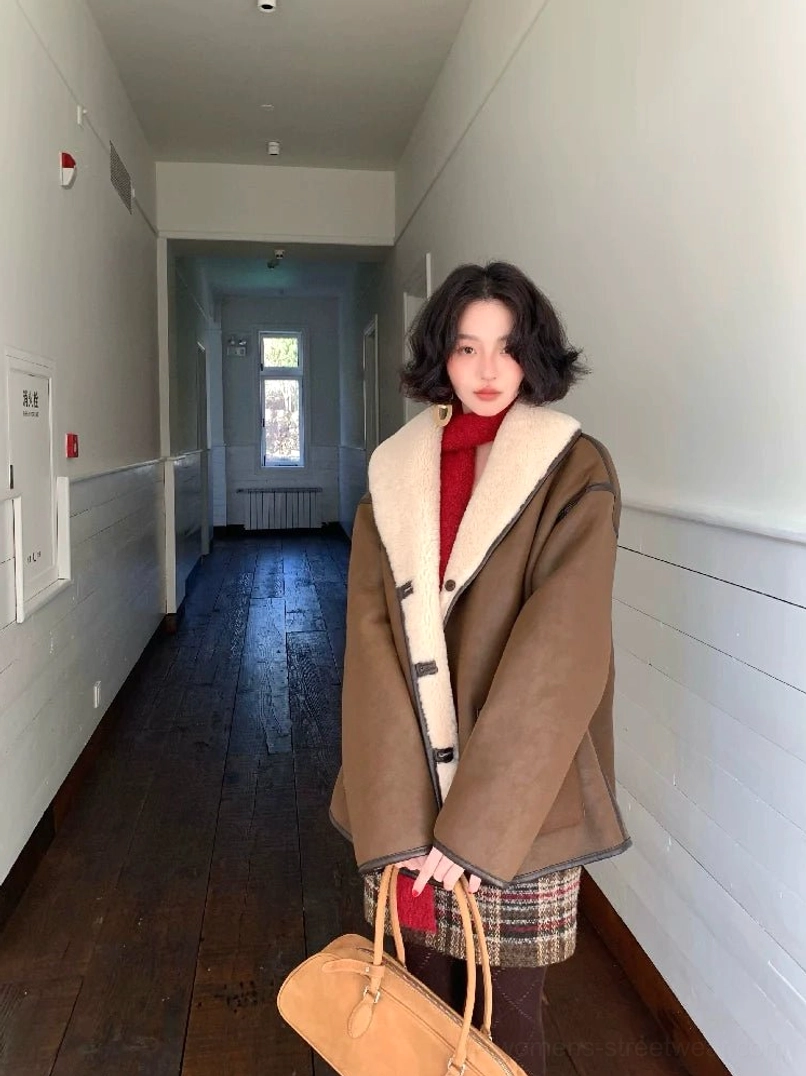 Front view of a brown oversized reversible shearling jacket worn with a red turtleneck and leather tote bag for a relaxed Seoul-inspired streetwear outfit