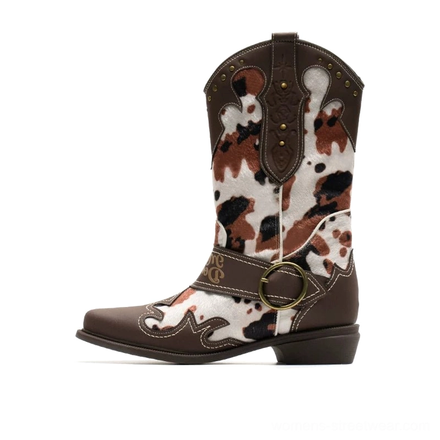 Brown patterned women's western cowboy boots with cow print upper panels, studded collar trim, D-ring buckle strap, and classic pointed toes