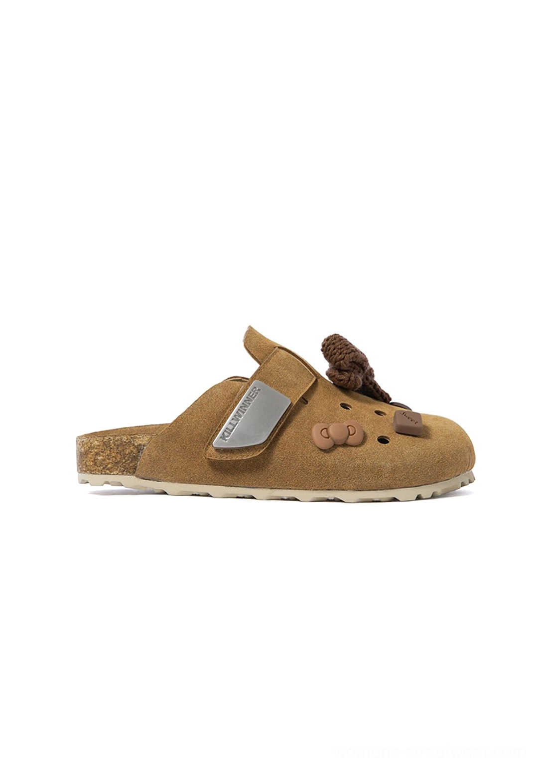 Right side view of a brown perforated streetwear clog showing decorative buttons, metal side plaque, textured sole edge, and open-back shape