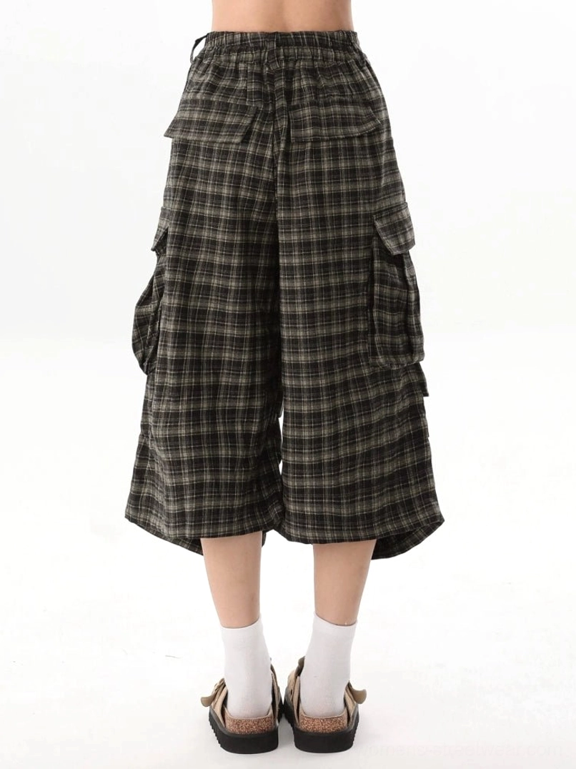 Rear view of brown plaid cargo culotte shorts showing elastic back waistband, relaxed cropped silhouette, side pockets, and back pockets