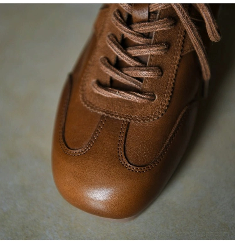 Close-up of brown retro leather sneaker toe and lacing area with smooth leather, suede overlay, neat stitch trim, and streetwear styling
