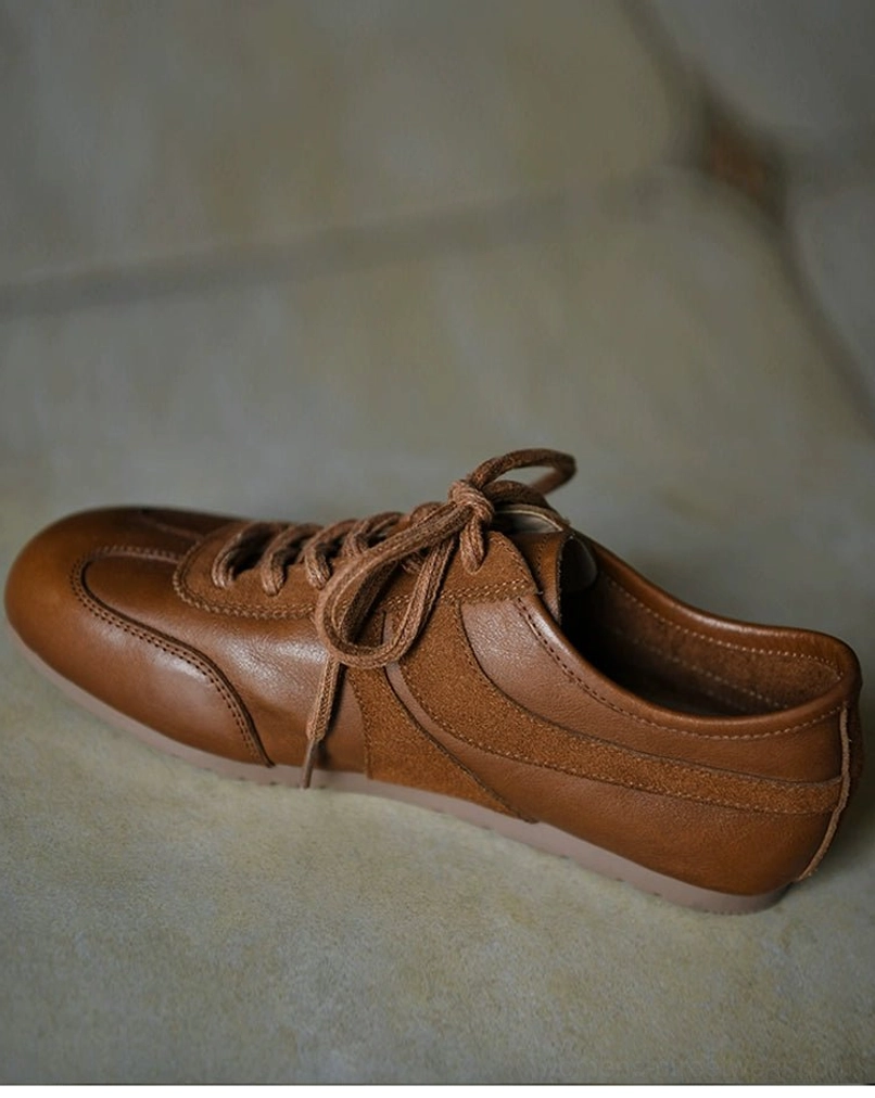 Brown retro leather sneakers with mixed suede and smooth leather upper, matching brown laces, low flat outsole, and minimalist streetwear shape