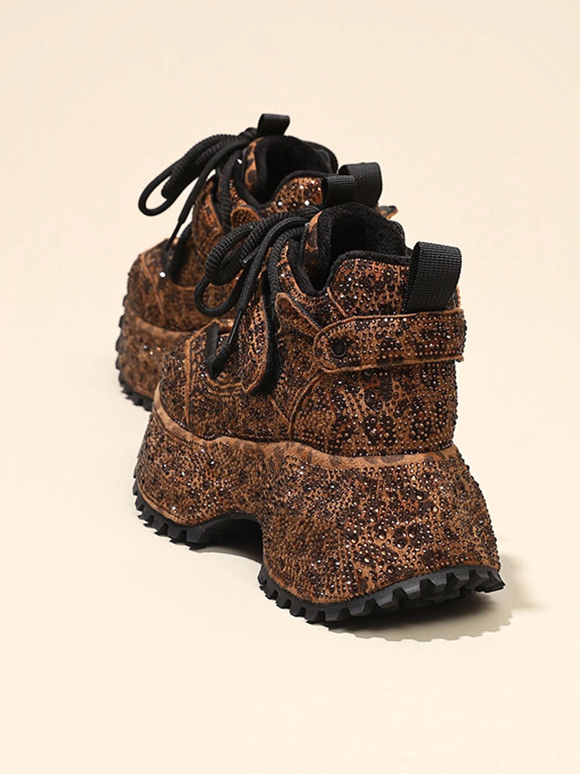 Side rear three-quarter view of brown rhinestone leopard platform sneakers with black laces and strap