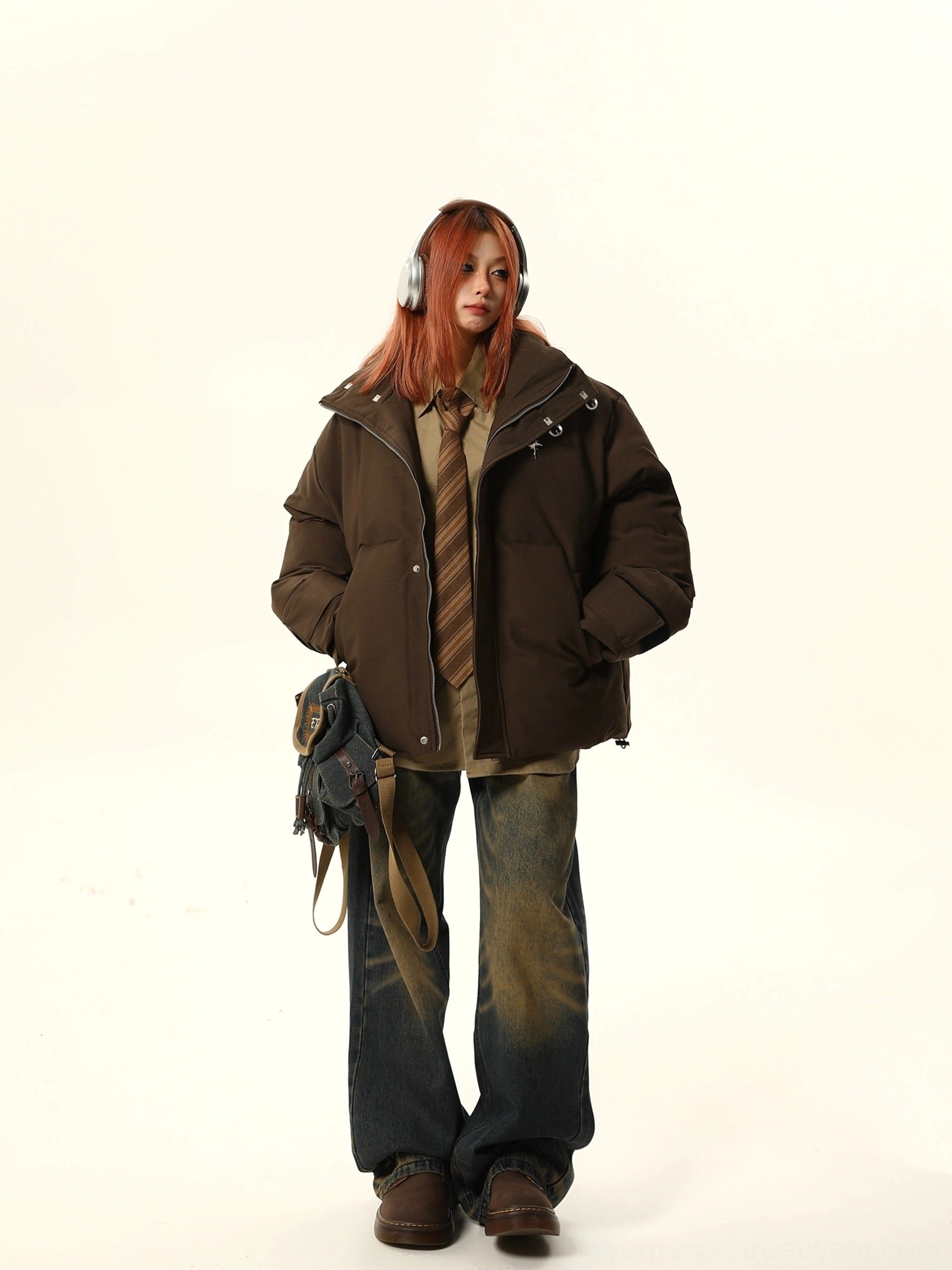 Oversized brown stand collar puffer jacket layered over shirt and tie in Seoul streetwear outfit