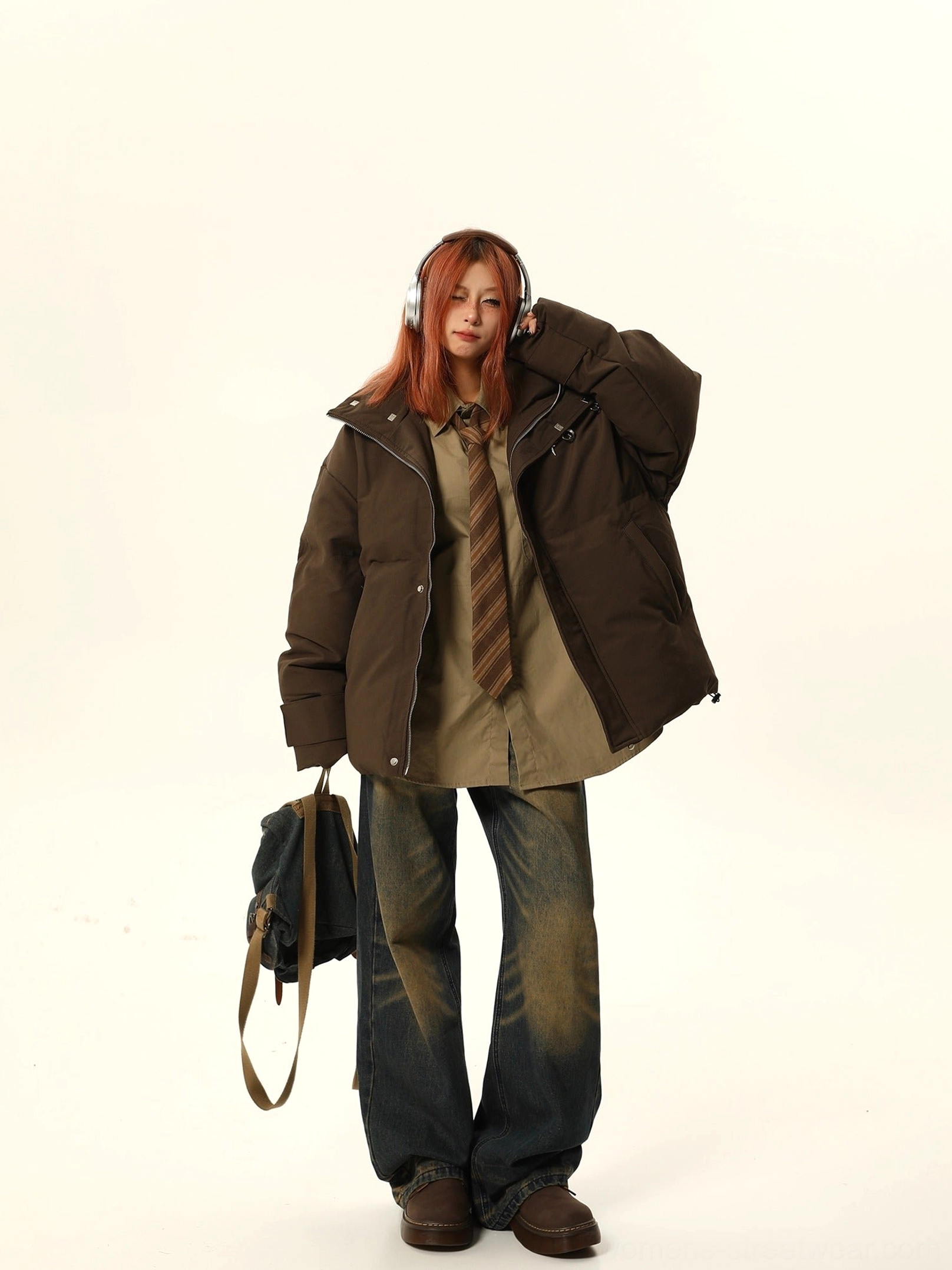 Brown oversized star embroidered puffer jacket open front view with relaxed layered styling