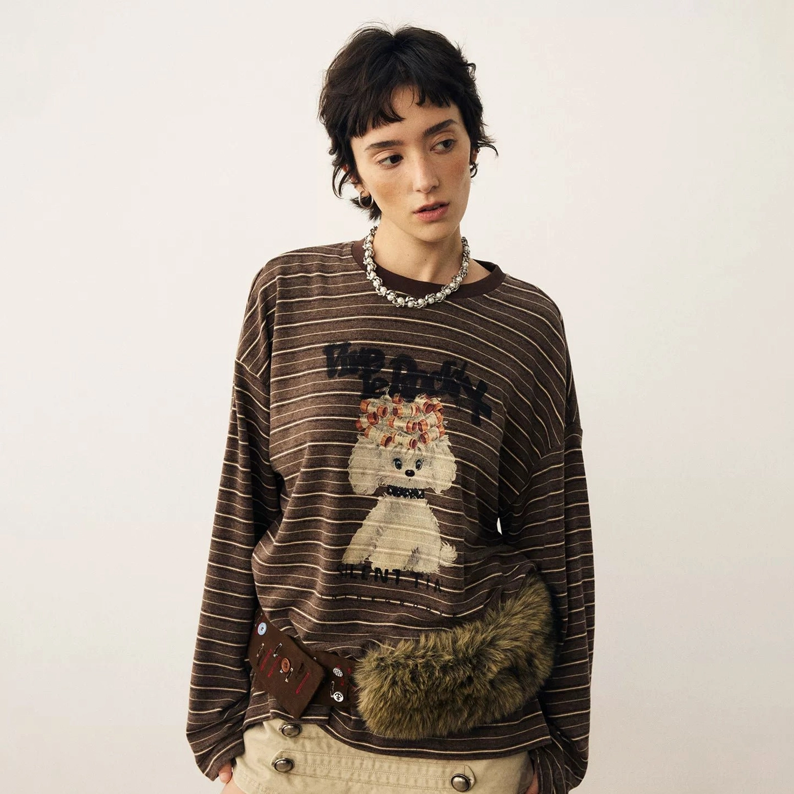 Detailed front view of brown striped puppy graphic long sleeve t-shirt with playful cartoon print and lettering