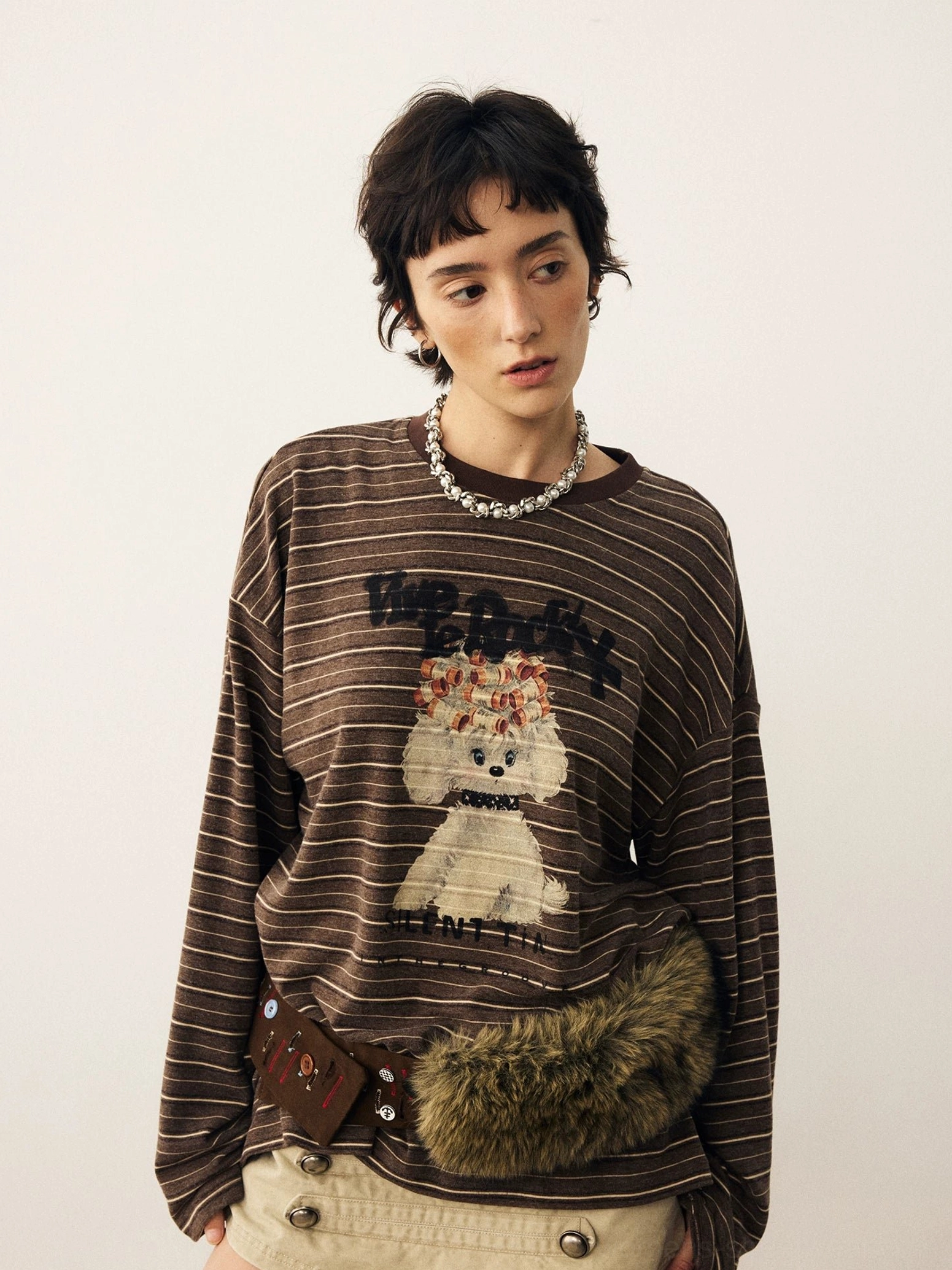 Close-up of puppy illustration and lettering on brown striped Korean streetwear long sleeve t-shirt