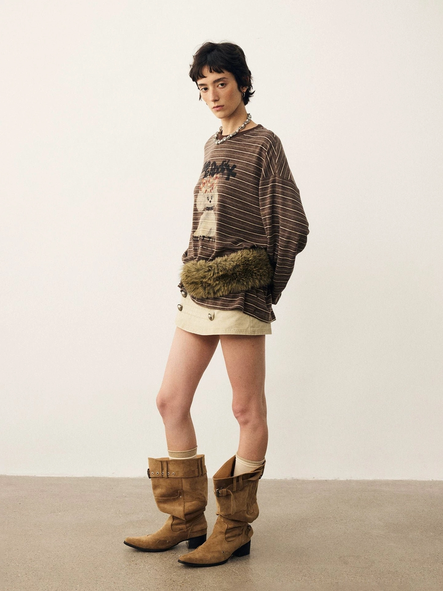 Side view of brown striped puppy graphic loose fit long sleeve t-shirt showing relaxed draped silhouette