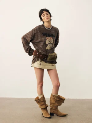 Brown striped puppy graphic oversized long sleeve t-shirt styled with beige mini skirt and western boots front view