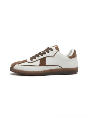 Brown suede panel and white leather retro streetwear trainers with brown laces and gum rubber sole front side studio view