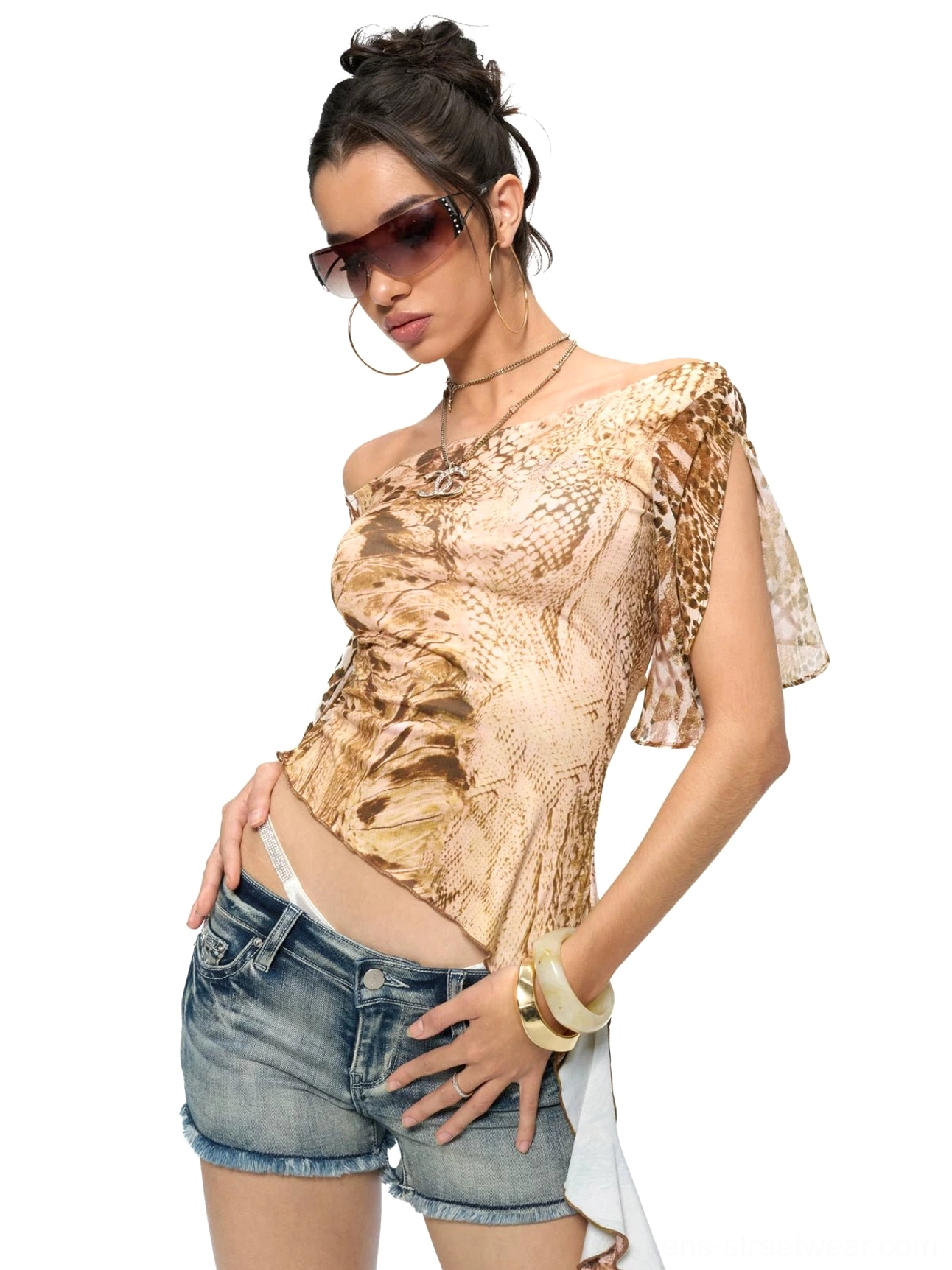 Front three-quarter view of a brown and tan animal print asymmetric top with flutter ruffle sleeves and uneven hem