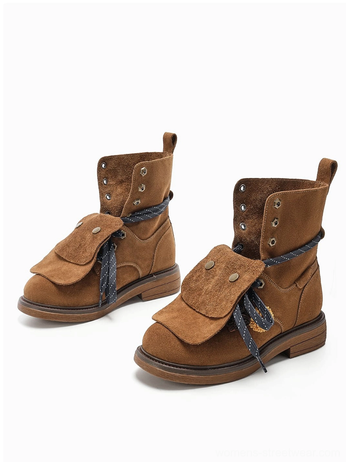 Front-side view of brown tassel-flap suede-look ankle boots highlighting the rounded toe, braided laces, and layered flap detail