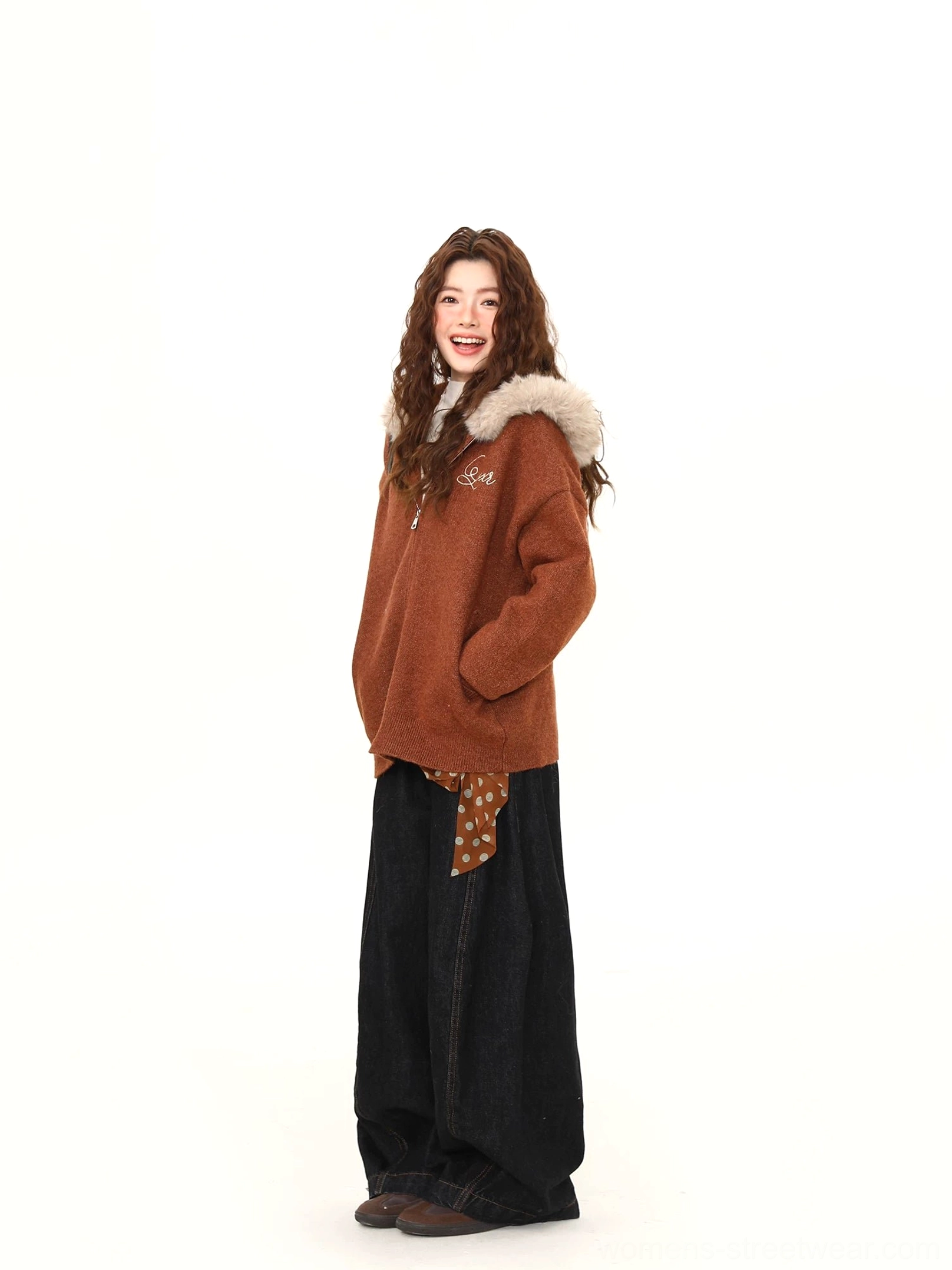 Side view of a brown oversized-inspired teddy zip hoodie jacket showing relaxed sleeves, hood trim, and functional pocket