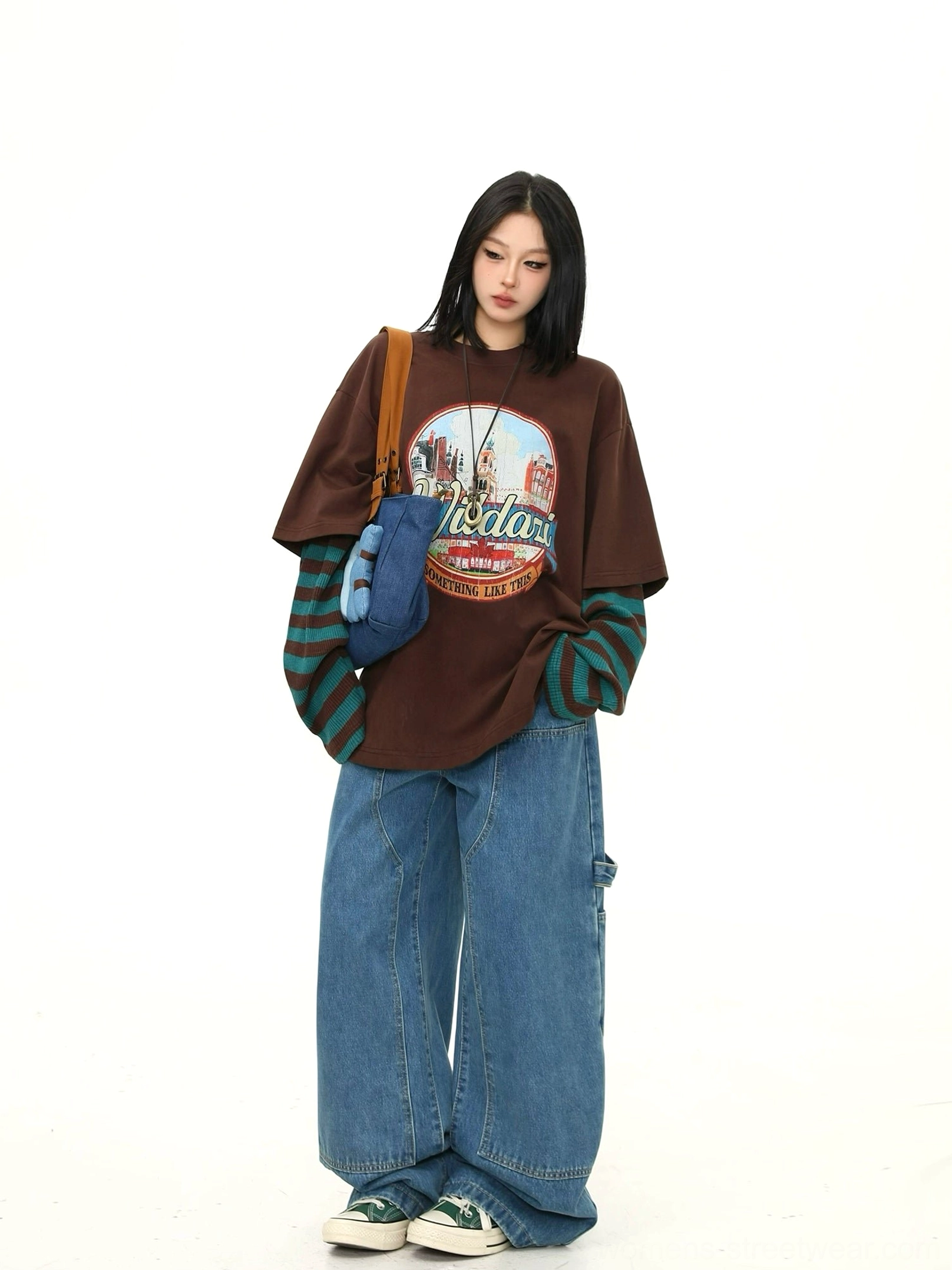 Right-side view of a loose brown vintage graphic T-shirt with faux two-piece striped sleeves styled for casual Korean-inspired streetwear