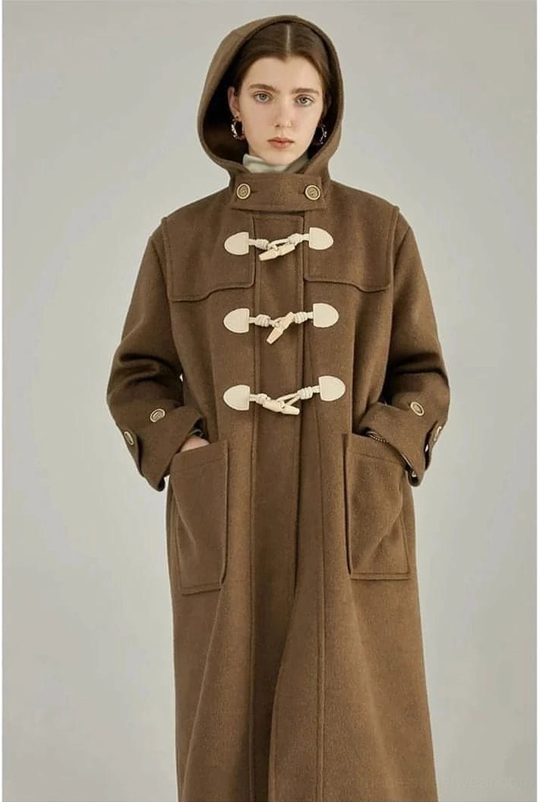 Brown wool duffle coat with horn toggle closures front view model wearing coat with hands in pockets