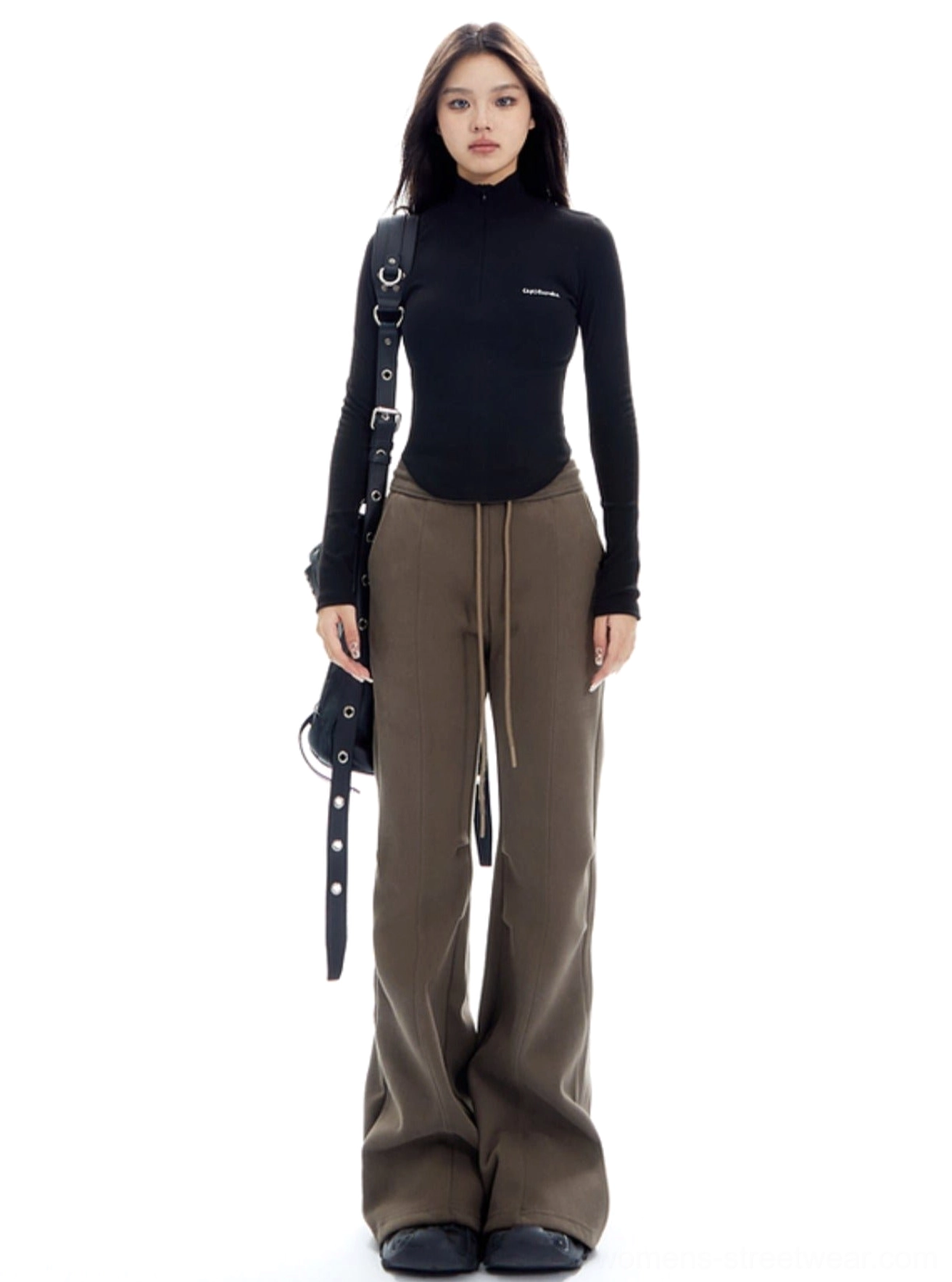 Brown Y2K flared streetwear trousers styled with a black cropped turtleneck and crossbody bag