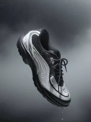 Brushed silver lunar wave retro tech running sneaker floating in dark studio with metallic silver and black mesh upper