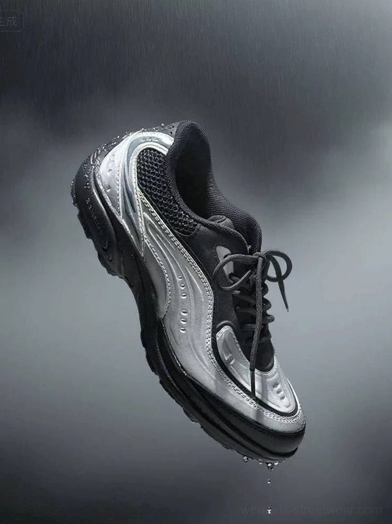 Brushed silver lunar wave retro tech running sneaker floating in dark studio with metallic silver and black mesh upper