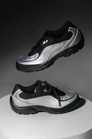 Pair of brushed silver lunar wave retro running sneakers showing wavy side panels thick rubber outsole and lace-up design