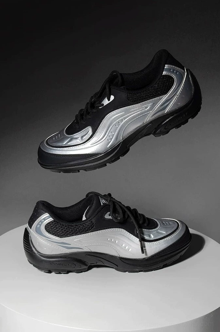 Pair of brushed silver lunar wave retro running sneakers showing wavy side panels thick rubber outsole and lace-up design