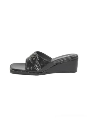 Black patent-effect buckled square-toe low-wedge slide sandals with studded sole trim and polished buckle hardware