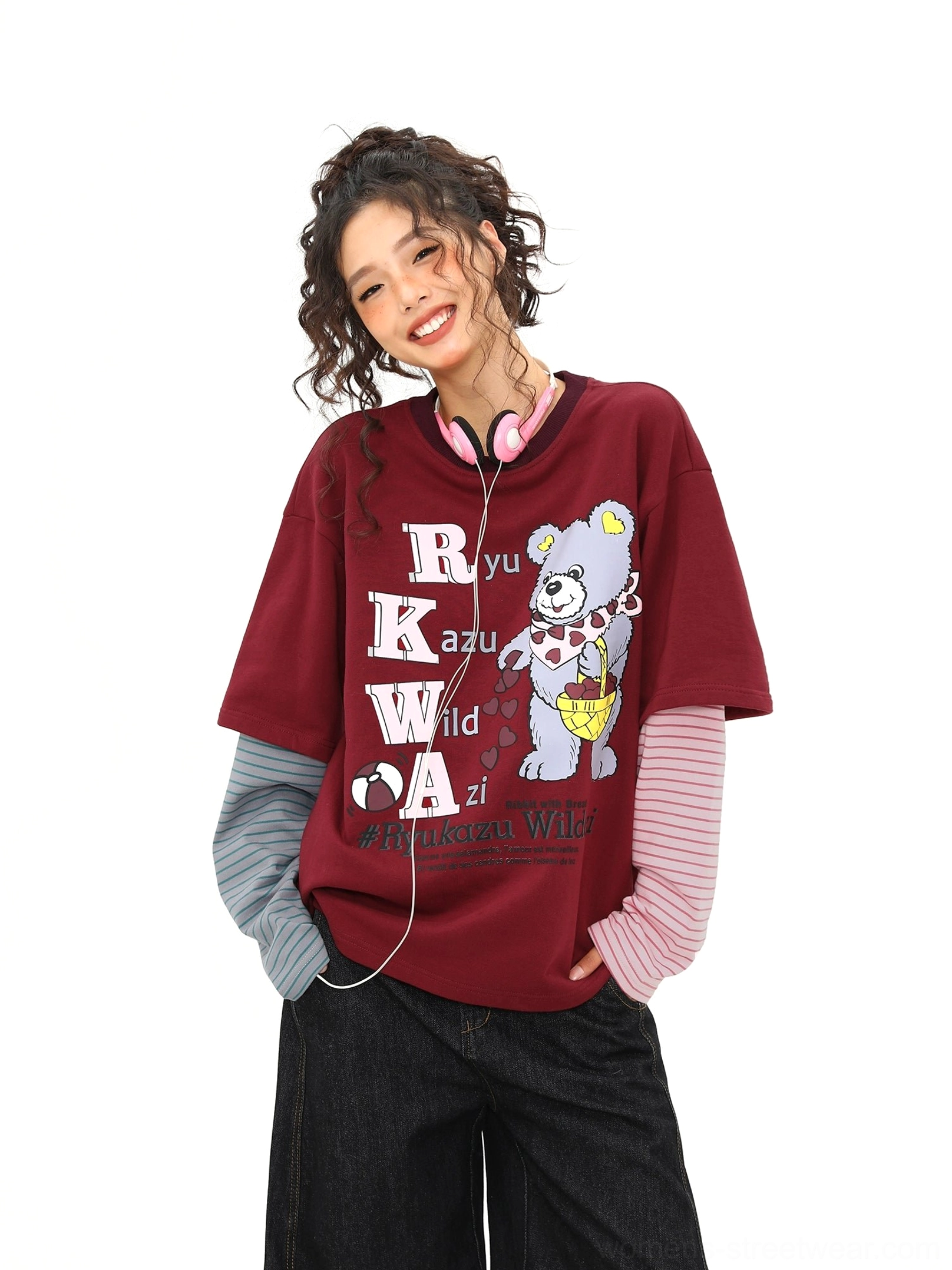Front three-quarter view of a burgundy oversized bear graphic layered tee with pink and grey striped sleeves in Y2K Korean streetwear style