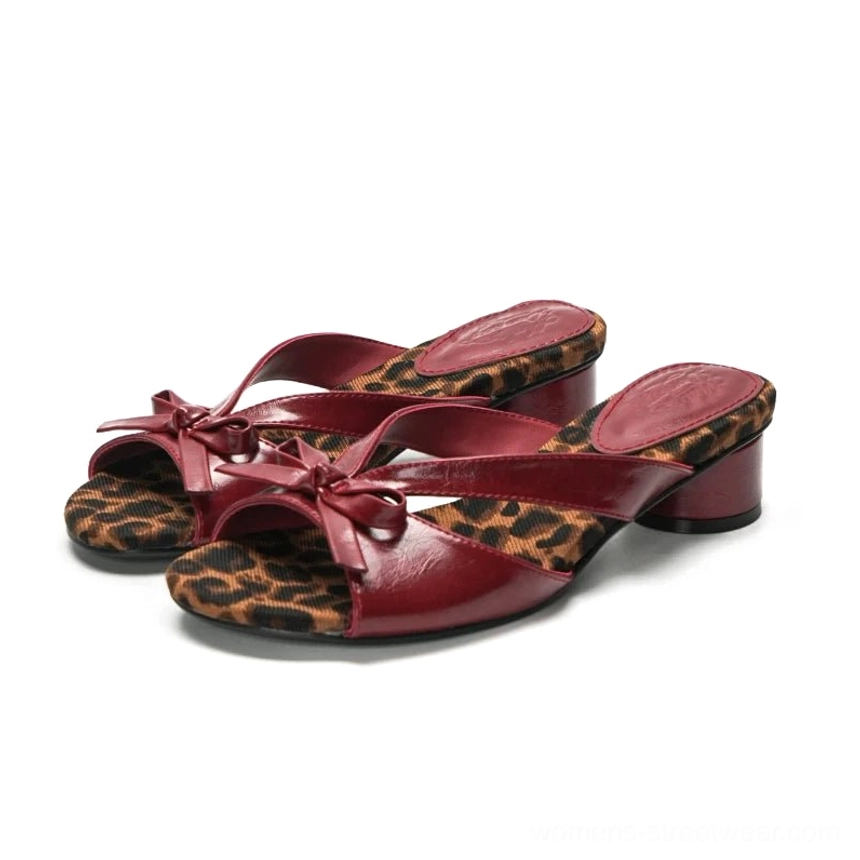 Burgundy bow accent low block heel mules with leopard print lining shown on white background