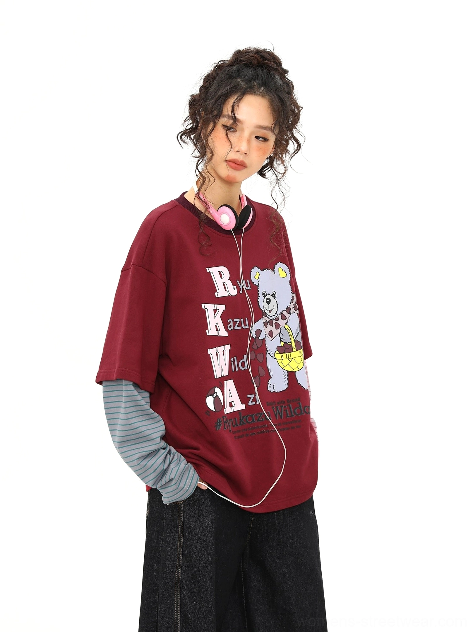 Side front view of a burgundy fake layered graphic tee featuring a cartoon bear print and contrasting striped long sleeves