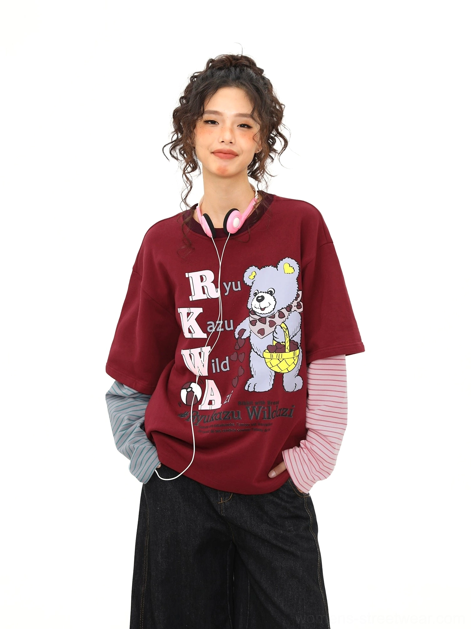 Front view of a burgundy fake two-piece graphic T-shirt with headphone bear print, retro lettering, and contrasting pink grey striped sleeves