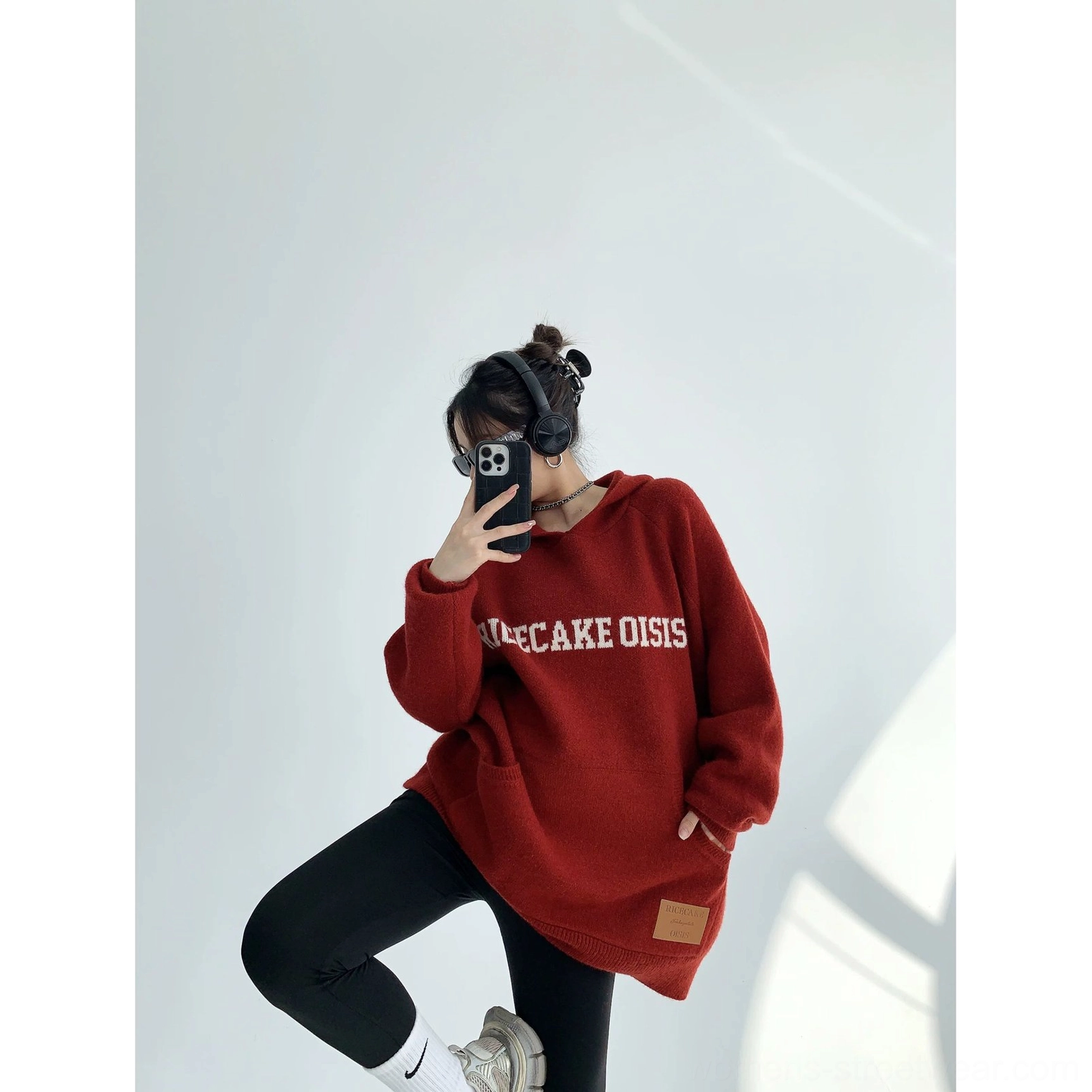 Burgundy oversized graphic hoodie with front lettering, kangaroo pocket, soft thick knit texture, and extended sleeves