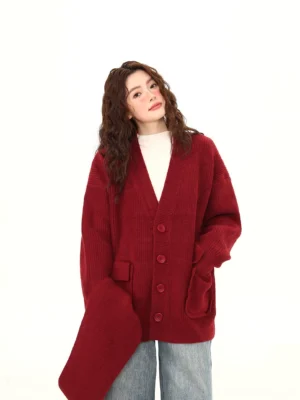 Burgundy oversized knit cardigan with matching scarf styled with a white turtleneck and wide-leg blue jeans