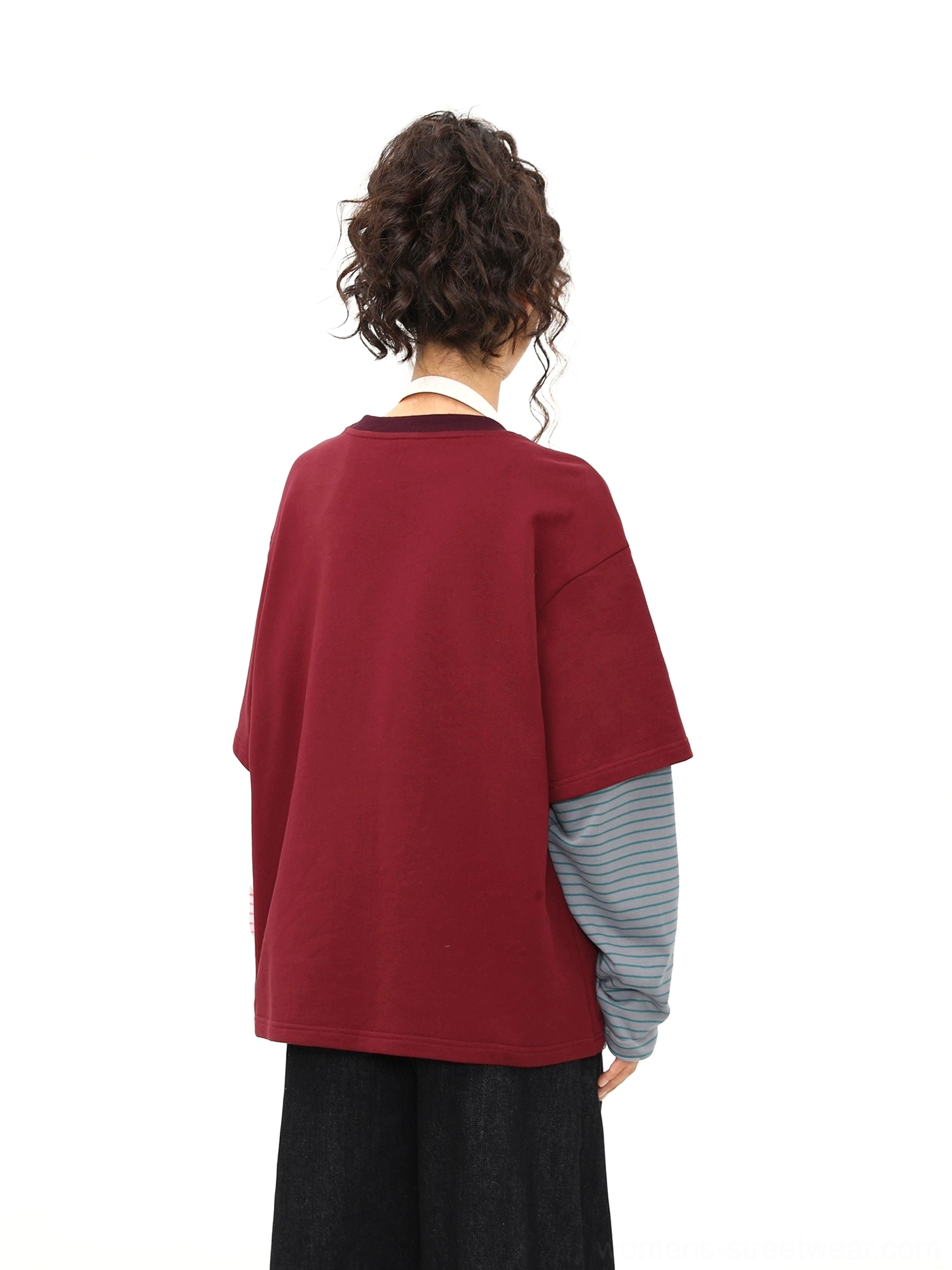 Back view of a burgundy oversized layered streetwear T-shirt showing the clean back and contrasting grey striped sleeve detail