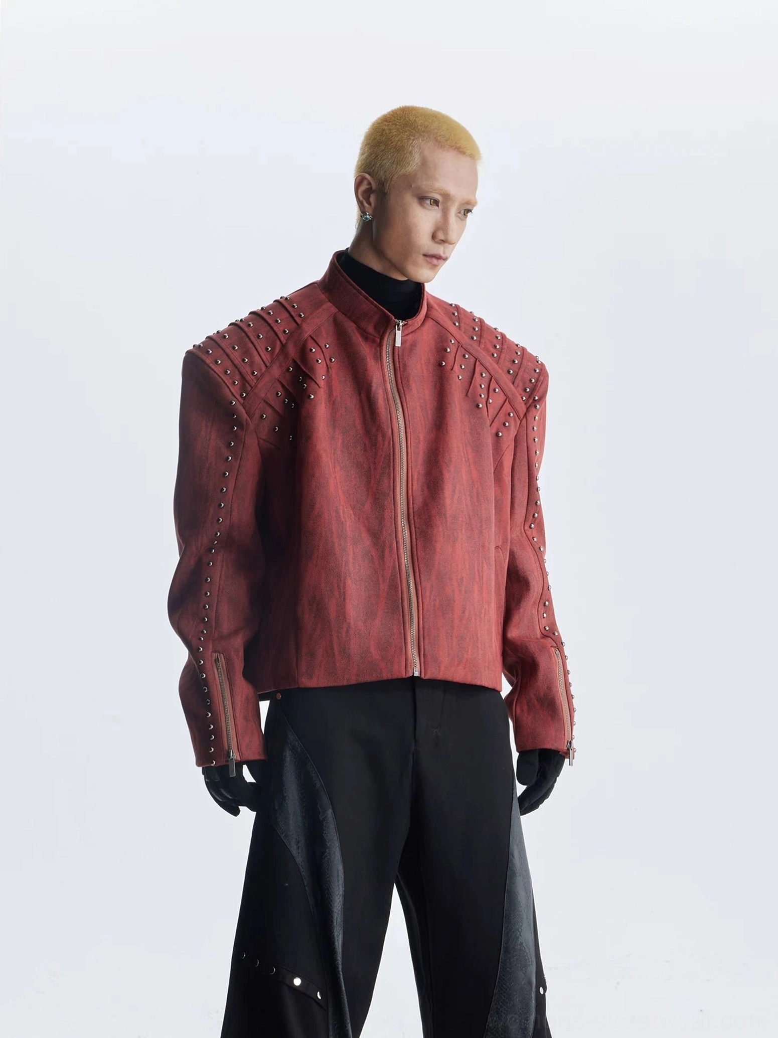 Full front view of burgundy red oversized studded moto jacket with structured shoulders and front zip closure