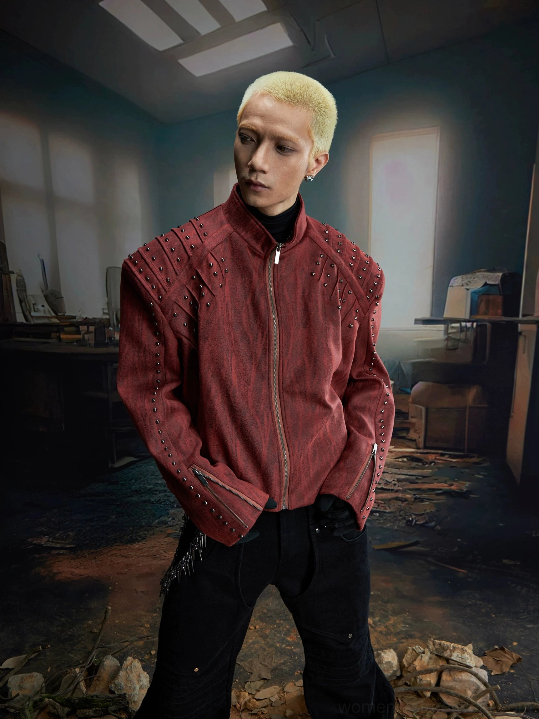Three-quarter view of burgundy red studded biker jacket with stand collar and oversized relaxed streetwear silhouette