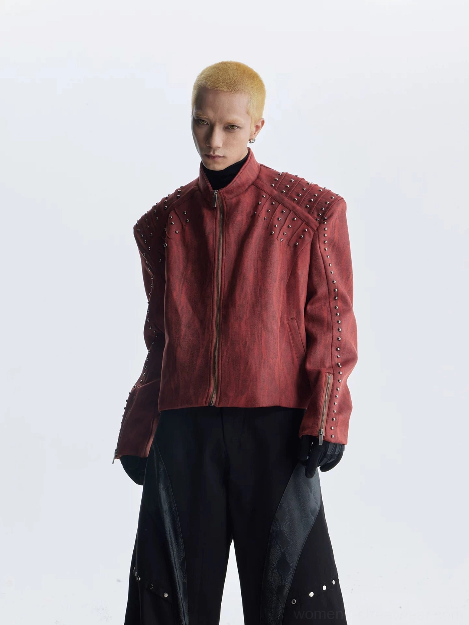 Burgundy red studded faux leather jacket with streamlined oversized silhouette and metallic shoulder decorations