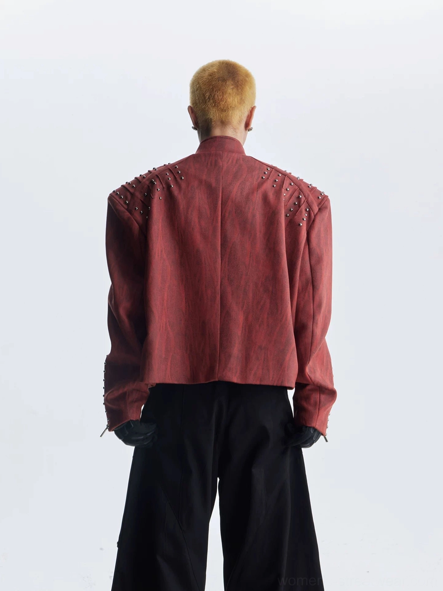 Rear view of burgundy red studded moto jacket showing cropped loose back and upper shoulder rivet details