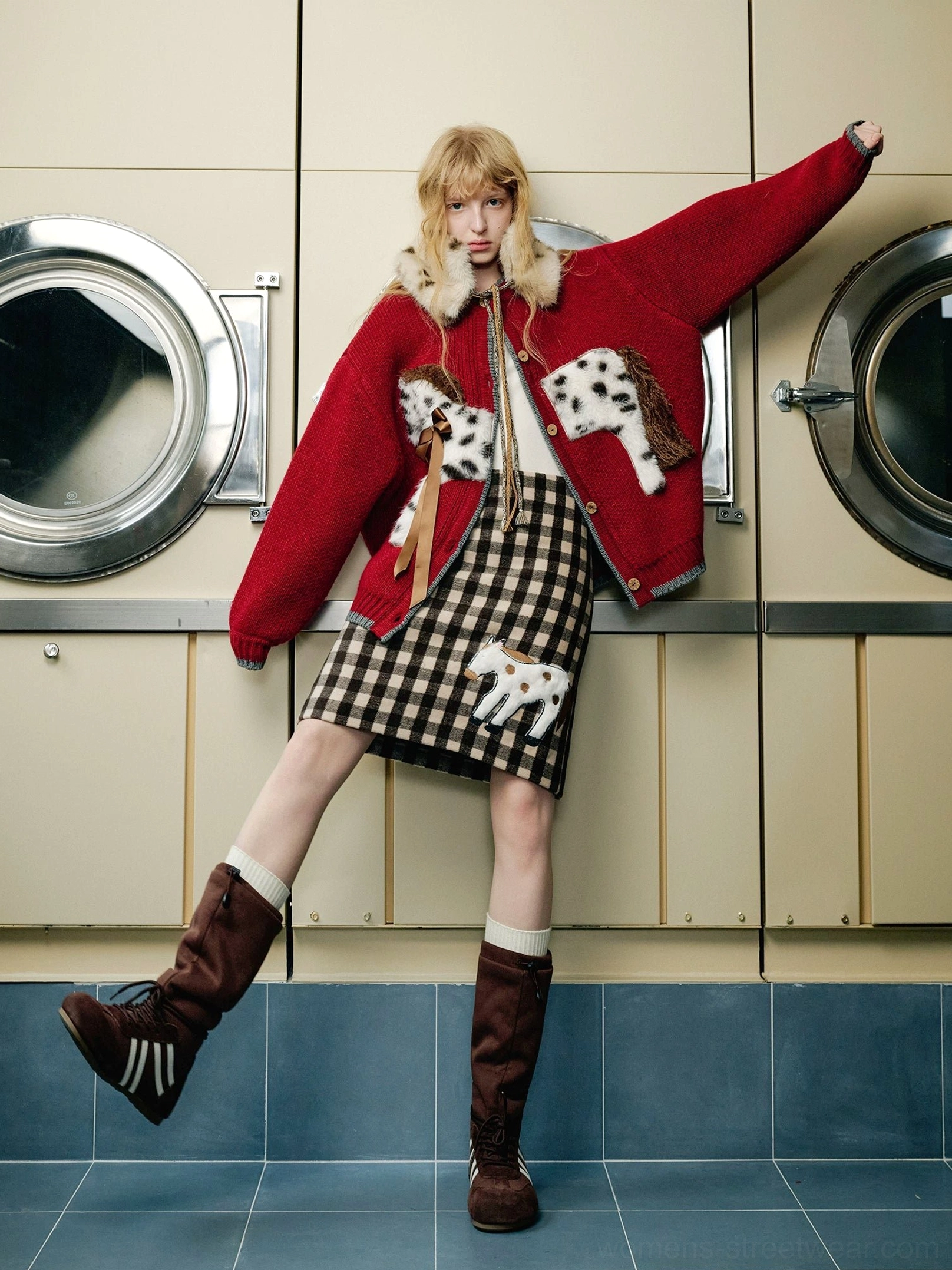 Burgundy spotted pony knit cardigan worn with gingham skirt and brown knee high boots in a laundromat