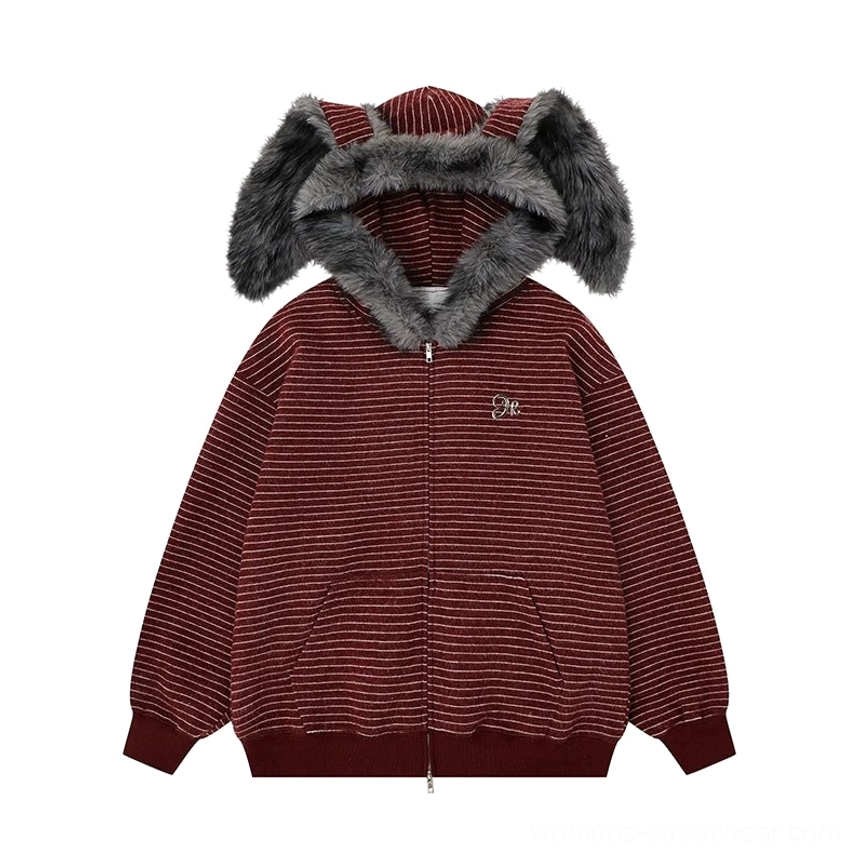 Flat lay display of a burgundy striped bunny-ear zip-up hoodie with dark gray faux-fur hood, front zipper, and subtle chest embroidery