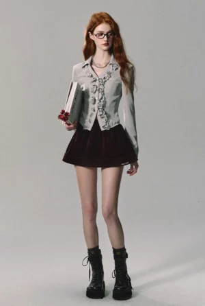 Burgundy velvet pleated mini skirt styled with a cropped ruffled shirt, combat boots, and a bouquet for a Y2K streetwear outfit