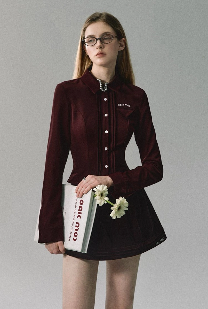 Burgundy velvet pleated mini skirt with matching collared blouse, brooch detail, and Korean-inspired fashion styling