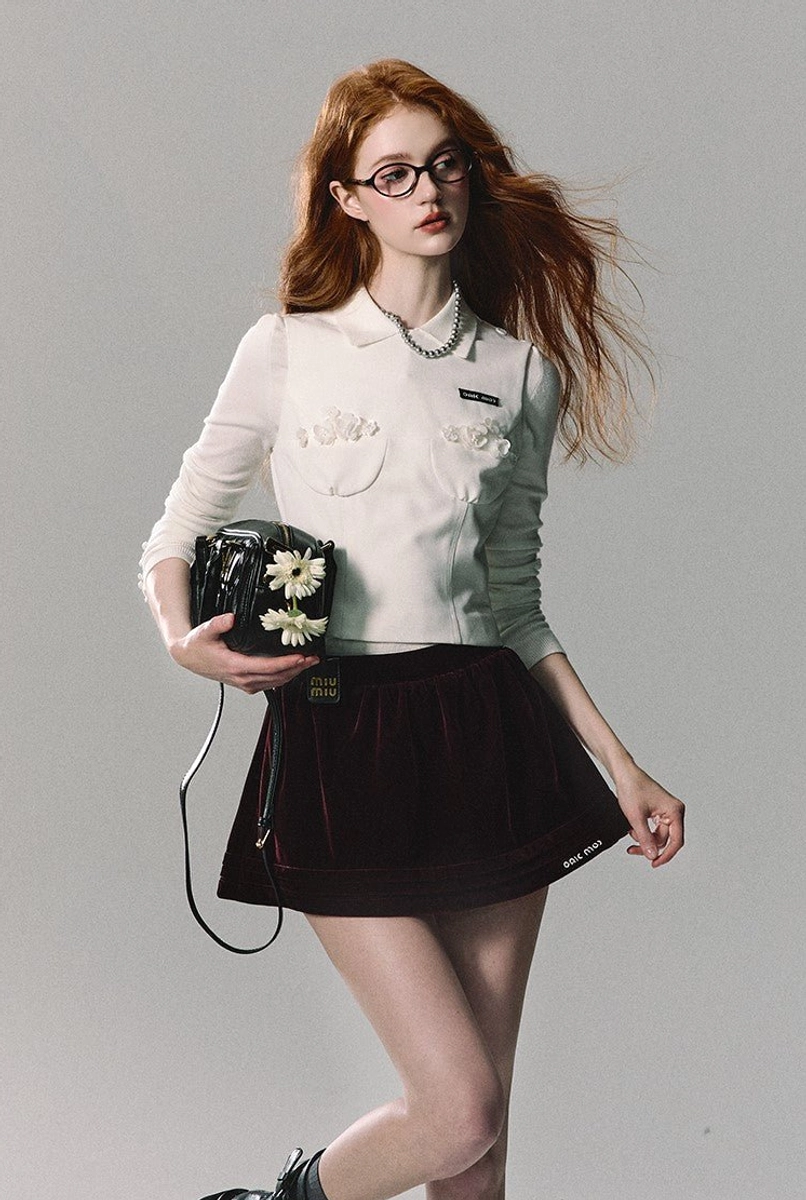 Burgundy velvet pleated mini skirt for women with a flared A-line silhouette and modern Seoul streetwear styling