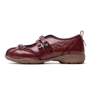 Burgundy waxed leather rivet harness Mary Jane flats with dual silver buckle straps and brown rubber outsole